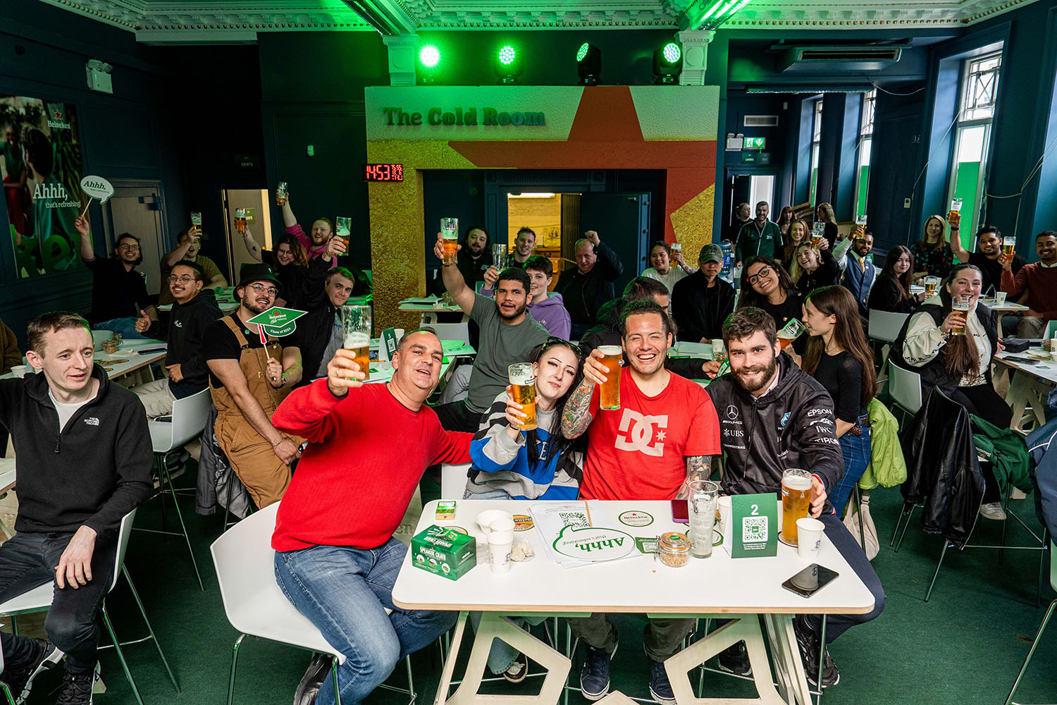 Ahhh‑cademy participants raising their drinks in the Cold Room